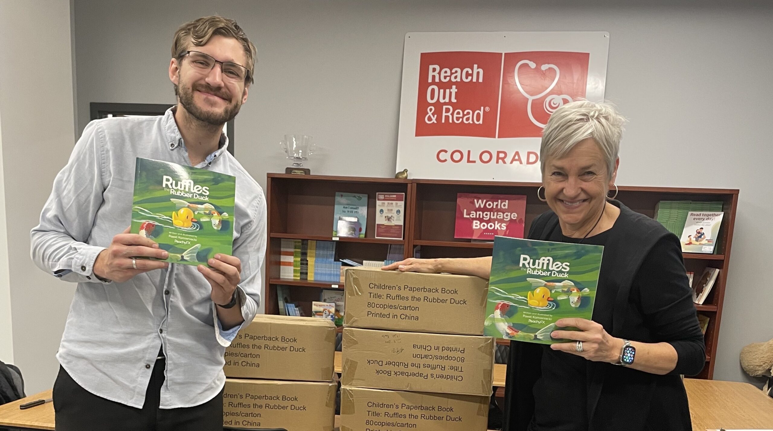Pawel Kamieniecki donates books to Reach Out and Read Colorado